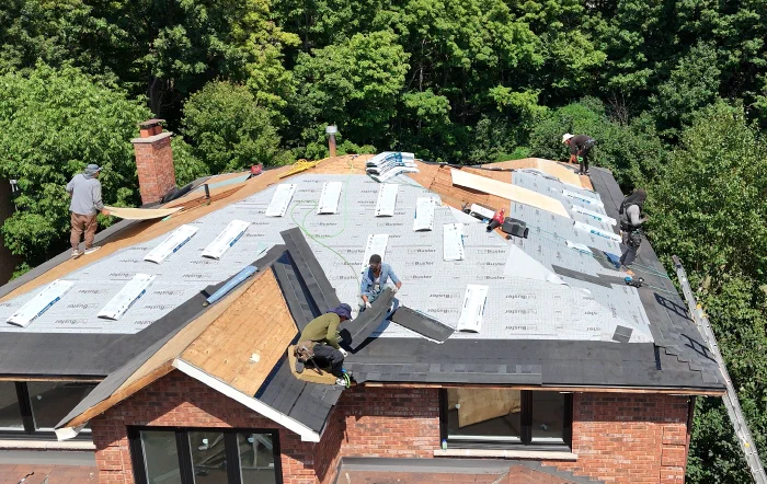 Roofing installation crew working on a new roof